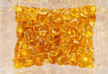 Yellow amber stones closeup lie on a flat surface