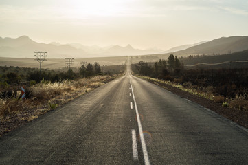 Driving into the Sunset on a Highway in a Mountain Landscape, Western Cape, South Africa