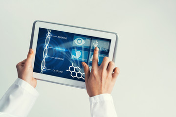 Close of female doctor hands working with tablet pc computer