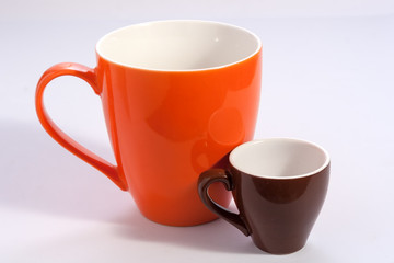 Two cups one big orange and one small brown