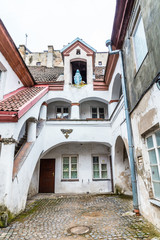 Fototapeta na wymiar Small courtyard with a sculpture of Maria old town Vilnius Lithuania