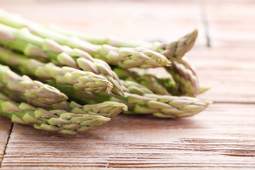 Green asparagus on brown wooden table
