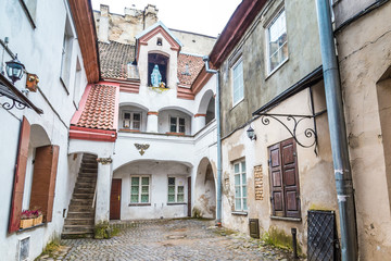 Fototapeta na wymiar Small courtyard with a sculpture of Maria old town Vilnius Lithuania