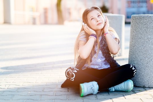 10 years old happy girl child listen to the music