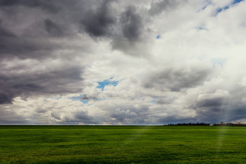 Obraz na płótnie Canvas Rural landscape - meadows with thunderclouds over them.