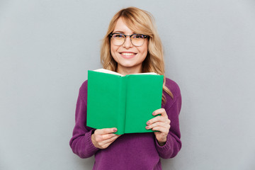 Woman with book smiling