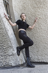 Portrait of a gothic teenage girl on a background of gothic architecture