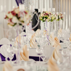 holiday wedding table in white tones with compositions of flowers and candles