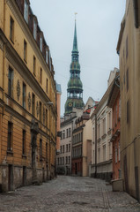 The street of old Riga. In the background, the tower of the church of St. Peter is visible.
