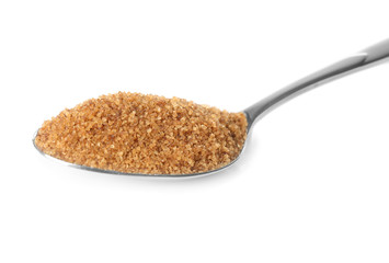Heap of brown sugar in spoon, isolated on white