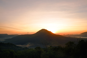 Summer view of soft orange sunset lights in Batur volcano, Kintamani, Bali island of Indonesia. Fantastic outdoor landscape at evening in Southeast Asia, travel adventure photography
