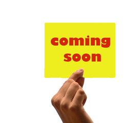 hand holding Coming Soon. note, white isolated background