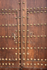 andalusian rustic wooden door with metal rivet