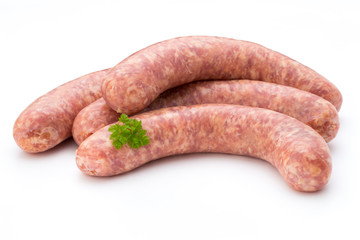 Raw sausage with parsley leaf isolated on white background.