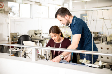 Supervisor and tailor working together