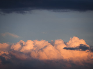 Blue sky with the soft pink colorful clouds at the sunset background