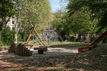Fototapeta na wymiar Empty playground in a urban backyard