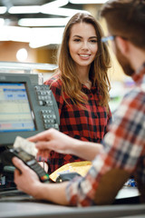Cashier man on workspace in supermarket shop create payment