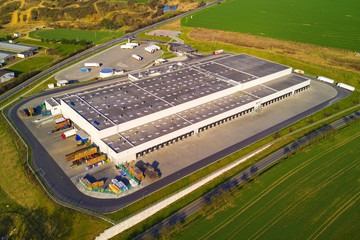 Aerial view of goods warehouse. Logistics center in industrial city zone from above.