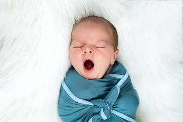 Close up of newborn baby boy yawning - obrazy, fototapety, plakaty