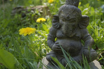 Fototapeta na wymiar ganesh stone statue decoration on the green grass