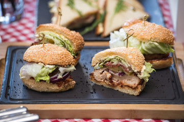 Fresh homemade burgers on wooden board in a restaurant