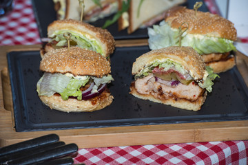 Fresh homemade burgers on wooden board in a restaurant
