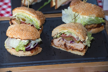 Fresh homemade burgers on wooden board in a restaurant