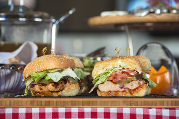 Fresh homemade burgers on wooden board in a restaurant