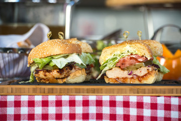 Fresh homemade burgers on wooden board in a restaurant