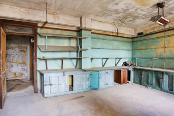 Old abandoned building in decay with broken glass and building materials