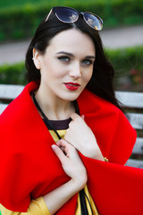 beautiful elegant woman on the street looks into the frame.