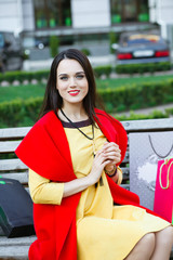 beautiful elegant woman on the street looks into the frame.