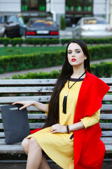beautiful elegant woman on the street looks into the frame.