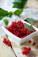 Berries of red currant on a wooden background. The concept of a healthy diet and diet.