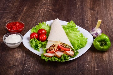 Burito with fried meat and tomatoes