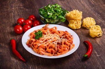 Chilli meat paste. Tagliatelle with beef and tomatoes