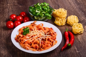 Chilli meat paste. Tagliatelle with beef and tomatoes