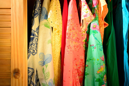 Summer clothing hanging in a closet