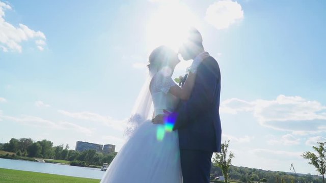 The bride and groom were frozen in bright sunlight