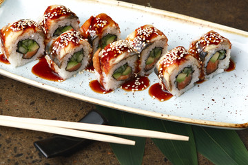 Sushi Roll with fish in a beautiful blue plate.