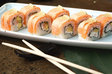 Sushi Roll with fish in a beautiful blue plate.