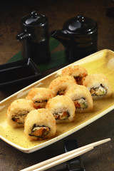 Sushi Roll with fish in a beautiful blue plate.