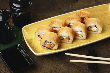 Sushi Roll with fish in a beautiful blue plate.