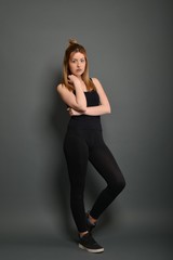 Naklejka premium Young brunette lady posing on grey background