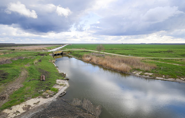 Fototapeta na wymiar Bridges through irrigation canals. Rice field irrigation system