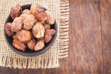sugared peanuts on the wooden background