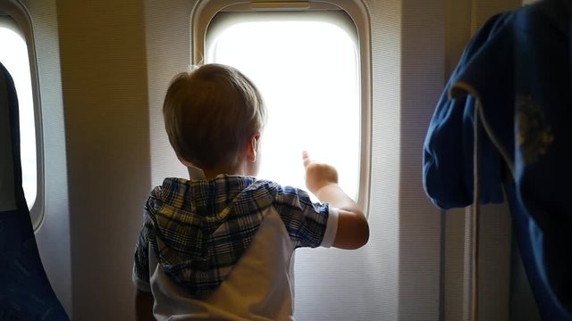 Little child looking out the airplane window