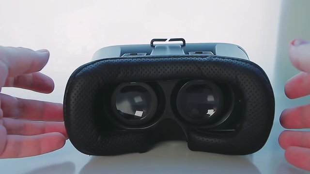 Man Puts Virtual Reality Glasses on Table