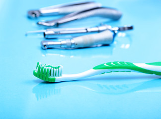 dental care toothbrush with dentist tools on mirror background.